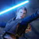 Young Jedi padawan Cal Kestis raises his hand, lightsaber ready, as he prepares for a fight.